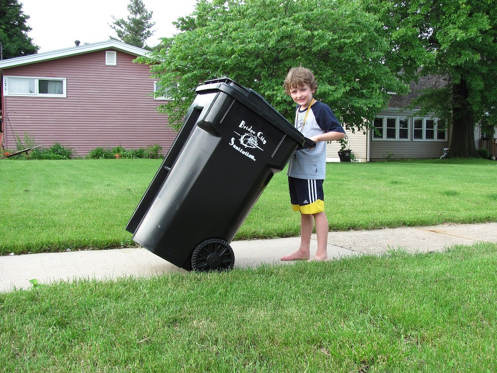 getting kids to clean | boy taking out garbage bin